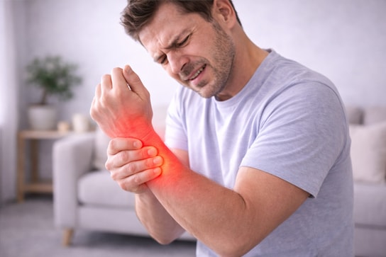 A chiropractor performing an assessment of a patient's arm and wrist to evaluate carpal tunnel symptoms