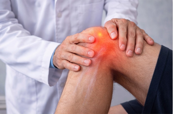 A patient receiving chiropractic care for a sore joint or ligament in their leg